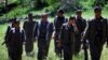 Rezan Javed (4 L), leader of the anti-Iranian group the Kurdistan Free Life Party (PJAK), is surrounded by militants as he makes his way to a press conference in the Qandil mountains of northern Iraq's Kurdish autonomous region, May 5,2014