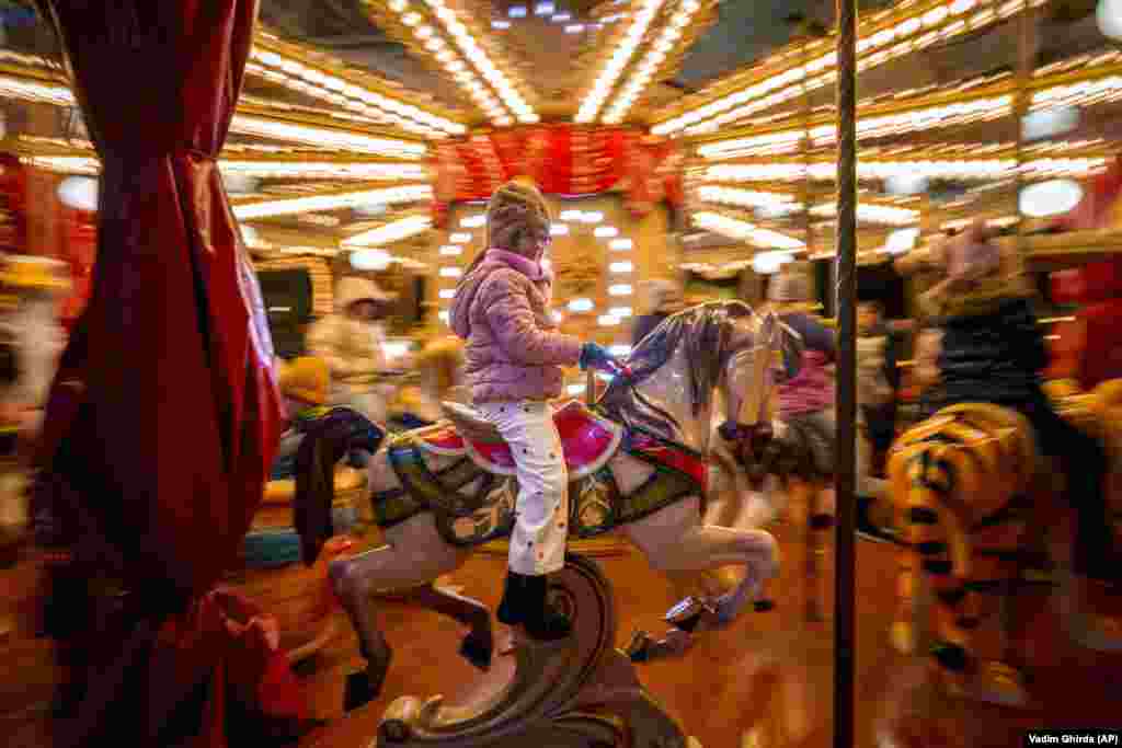 A child rides on a merry-go-round at Christmas fair in the Romanian capital, Bucharest.&nbsp;