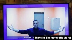 Russian opposition leader Aleksei Navalny is seen on a screen via a video link during a court hearing to consider an appeal on his arrest outside Moscow on January 28.