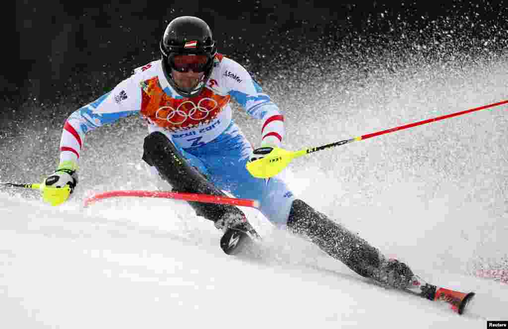 Austria&#39;s gold medal winner Mario Matt clears a gate during the first run of the men&#39;s alpine skiing slalom. (Reuters/Dominic Ebenbichler)