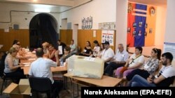 ARMENIA -- Members of a local election commission count votes at a polling station in Yerevan, June 20, 2021