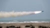 A missile is fired out to sea from a mobile launch vehicle during a military exercise in the Gulf of Oman, June 17, 2020