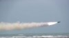 IRAN -- A missile is fired out to sea from a mobile launch vehicle during a military exercise in the Gulf of Oman, June 17, 2020