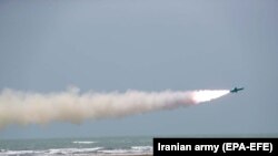 IRAN -- A missile is fired out to sea from a mobile launch vehicle during a military exercise in the Gulf of Oman, June 17, 2020