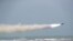 IRAN -- A missile is fired out to sea from a mobile launch vehicle during a military exercise in the Gulf of Oman, June 17, 2020