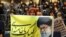 An Iranian girl holds a banner bearing a portrait of supreme leader Ayatollah Ali Khamenei during a campaign meeting of the head of the conservatives grand coalition in February.