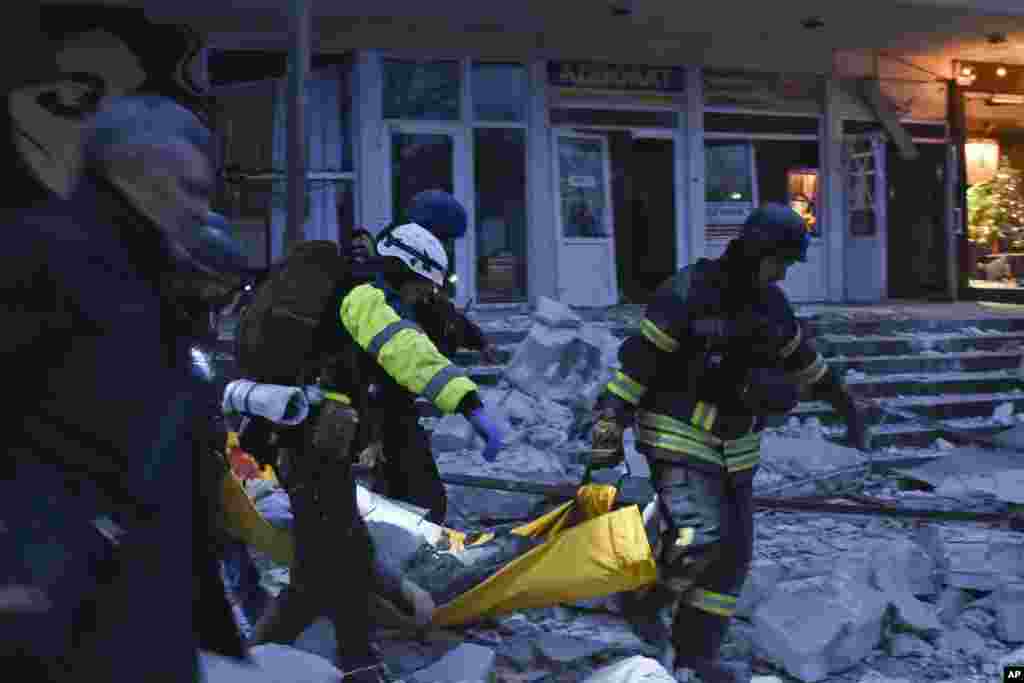  Rescuers carry a wounded civilian after a Russian missile hit a private medical clinic in Zaporizhzhya, Ukraine. &nbsp; 