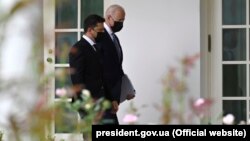 Volodymyr ZelenskIy (left) and Joe Biden walk in the White House in Washington during their meeting in September.