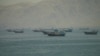 Vessels are stranded near the Strait of Hormuz amid reports of a tentative deal to extend the cease-fire and allow traffic to flow through the waterway.