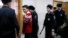 Ukrainian military pilot Nadia Savchenko (second from left) is escorted inside a court building as she attends a hearing in Moscow on March 4.
