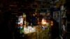 An Iranian shop operates in the dark after a blackout in the capital, Tehran.