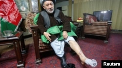 Ahmad Ishchi displays an injury on his leg during an interview at his home in Kabul on December 13.