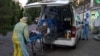 Armenia - An ambulance rescuer wearing personal protective equipment moves a patient into the Grigor Lusavorich Medical Centre in Yerevan on May 27, 2020, amid the COVID-19 pandemic.