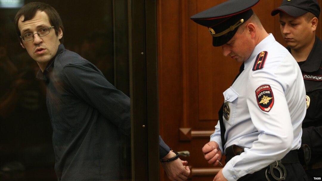 Leonid Kovyazin (left) appears in court for a hearing into the case over mass riots in Moscow's Bolotnaya Square during the opposition rally in May 2012.
