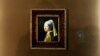 Italy --Journalists pass by the painting by Johannes Vermeer (1632-1675) entitled "the Girl with a Pearl Earring " during a preview of the exhibition " The Myth of the Golden Age, From Rembrandt to Vermeer " at Bologna's Palazzo Fava, January 30, 2014