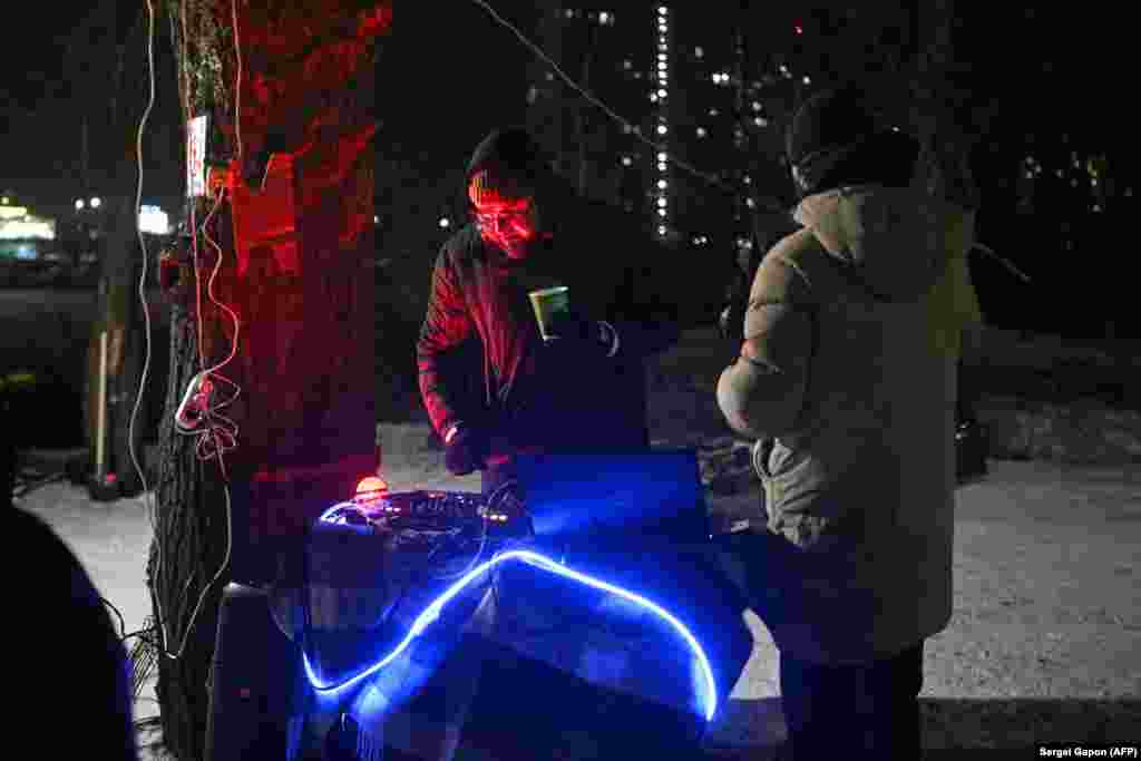 A DJ at the block party attended by residents affected by power outages in Kyiv.