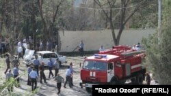 Policemen and firefighters work at the scene of the suicide bombing in Khujand on September 3, 2010.