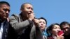 Businessman Tilek Toktogaziev (second from left), whom protesters demand be named as the country's new prime minister, speaks to people gathering in Bishkek on October 7.