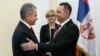 Serbian Defense Minister Aleksandar Vulin (right) welcomes Russian Defense Minister Sergei Shoigu to Belgrade on October 20.