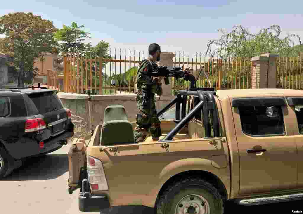 An Afghan soldier stands in a military vehicle on a street in Kabul. Taliban militants were seen on the outskirts of the capital on August 15, even as the government called for calm.