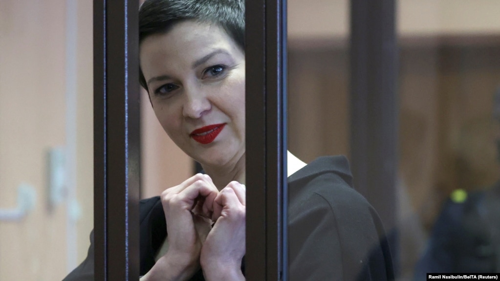 Maryya Kalesnikava forms a heart shape to supporters from inside a defendants' cage at her trial in Minsk on September 6.