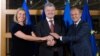 EU foreign policy chief Federica Mogherini (left), Ukrainian President Petro Poroshenko (center), and the president of the European Council, Donald Tusk, in Brussels on December 12