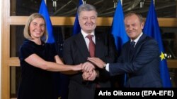 EU foreign policy chief Federica Mogherini (left), Ukrainian President Petro Poroshenko (center), and the president of the European Council, Donald Tusk, in Brussels on December 12