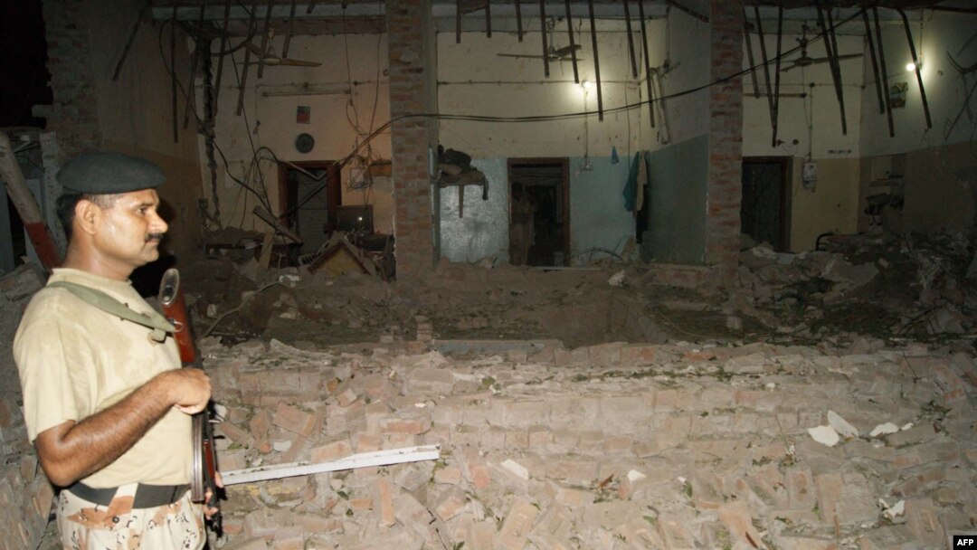 A Pakistani paramilitary soldier stands at the site of suicide car bombing in the southern city of Sukkur on July 24.