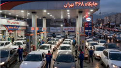Iranians line up in their vehicles to get gas at a station in Tehran. 