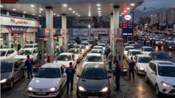 Iranians line up in their vehicles to get gas at a station in Tehran. 