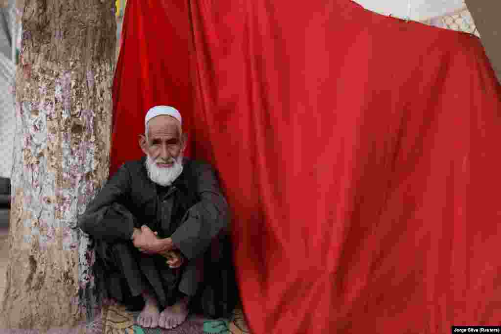 A displaced Afghan man sats at the makeshift shelter in the Shahr-e Naw park in Kabul on October 4.&nbsp;