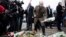 French Interior Minister Bernard Cazeneuve (center) lays flowers outside the Krystalgade synagogue in Copenhagen on February 15 after two attacks in the Danish capital, at a cultural center during a debate on Islam and free speech and a second outside a synagogue left two people dead.
