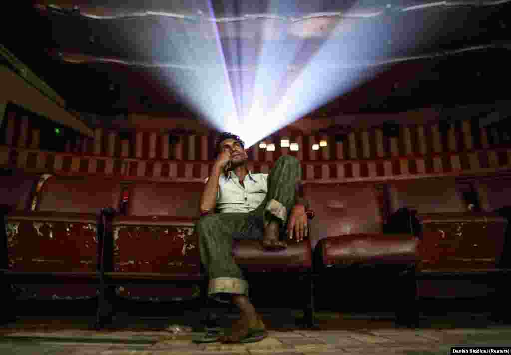 A lone moviegoer enjoys the classic Bollywood movie Dilwale Dulhania Le Jayenge (The Big Hearted Will Take the Bride) in a theater in Mumbai on December 11, 2014.&nbsp;