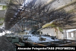 An armored vehicle fitted with netting and hedgehog armor at the Zaporizhzhya workshop