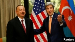 Austria - U.S. Secretary of State John Kerry (R) gestures next to President Ilham Aliyev of Azerbaijan during a bilateral meeting in Vienna, Austria, May 16, 2016