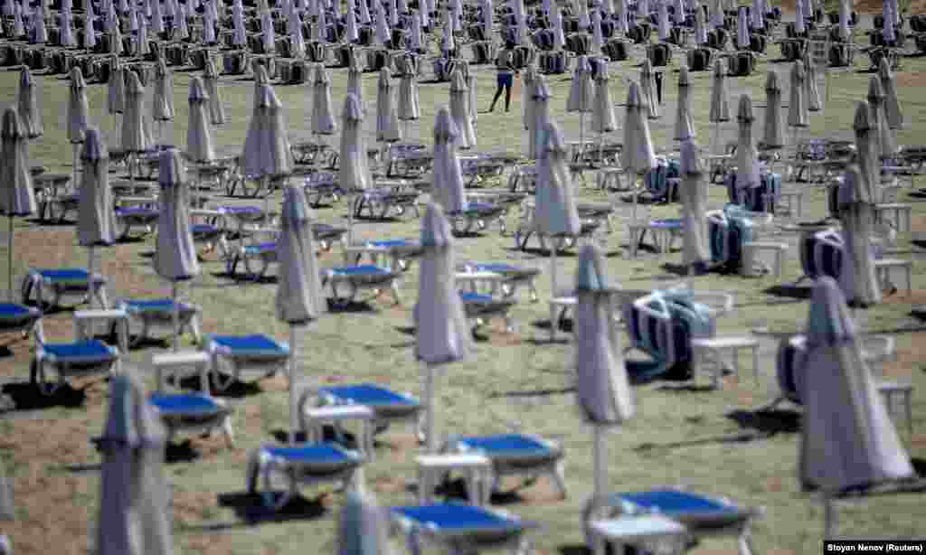 A man walks near empty sunbeds at a beach resort on the Black Sea in Bulgaria. (Reuters/Stoyan nenov)