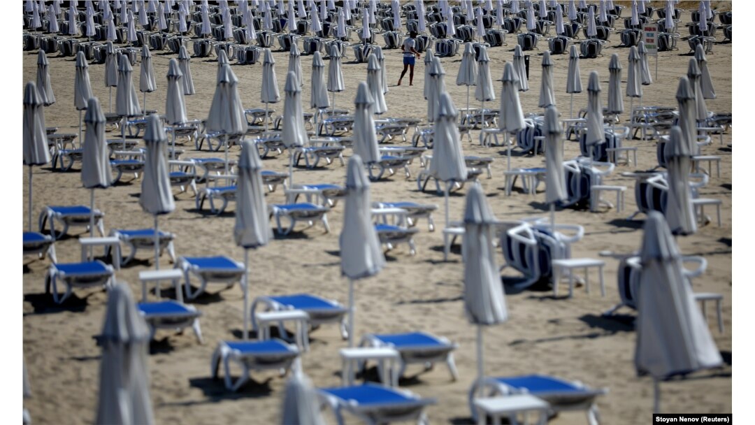 A man walks near empty sunbeds at Sunny Beach resort on Bulgaria's Black Sea coast on June 23.