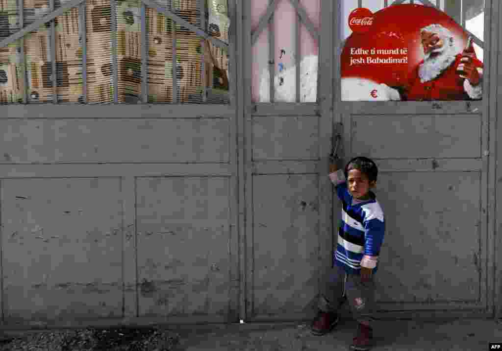 A Romany child stands in front of a shelter near the town of Gjakova, Kosovo. (AFP/Armend Nimani)