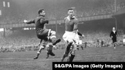 Chelsea's Reg Williams (right) rushes in to challenge Dynamo Moscow's Ivan Stankevich (left), deflecting the ball into the net for Chelsea's second goal, making the score 2-0.