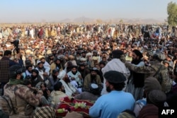Mourners and relatives of victims gather during the mass burial ceremony for the victims of the Pakistan air strike in Khost Province on November 25.