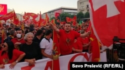 Protesters in Podgorica wave national flags to protest the use of Serbian national symbols by opposition parties that preliminary results show won elections last week.