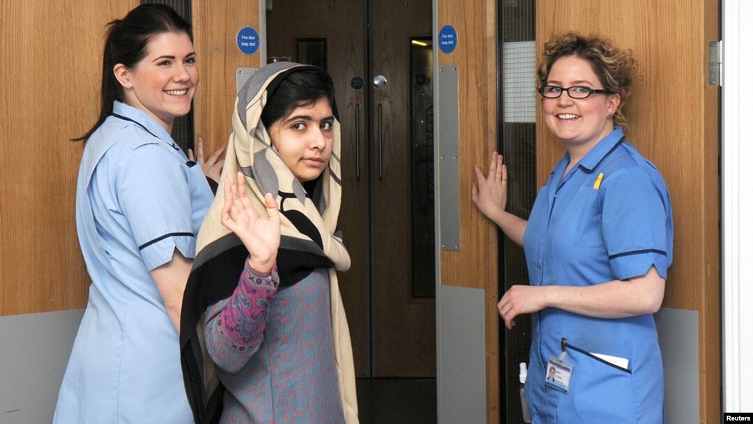 Pakistani schoolgirl Malala Yousafzai (center) waves with nurses as she is discharged from the Queen Elizabeth Hospital in Birmingham.