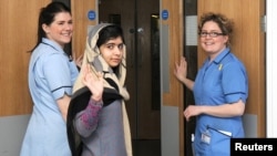 Pakistani schoolgirl Malala Yousafzai (center) waves with nurses as she is discharged from the Queen Elizabeth Hospital in Birmingham.