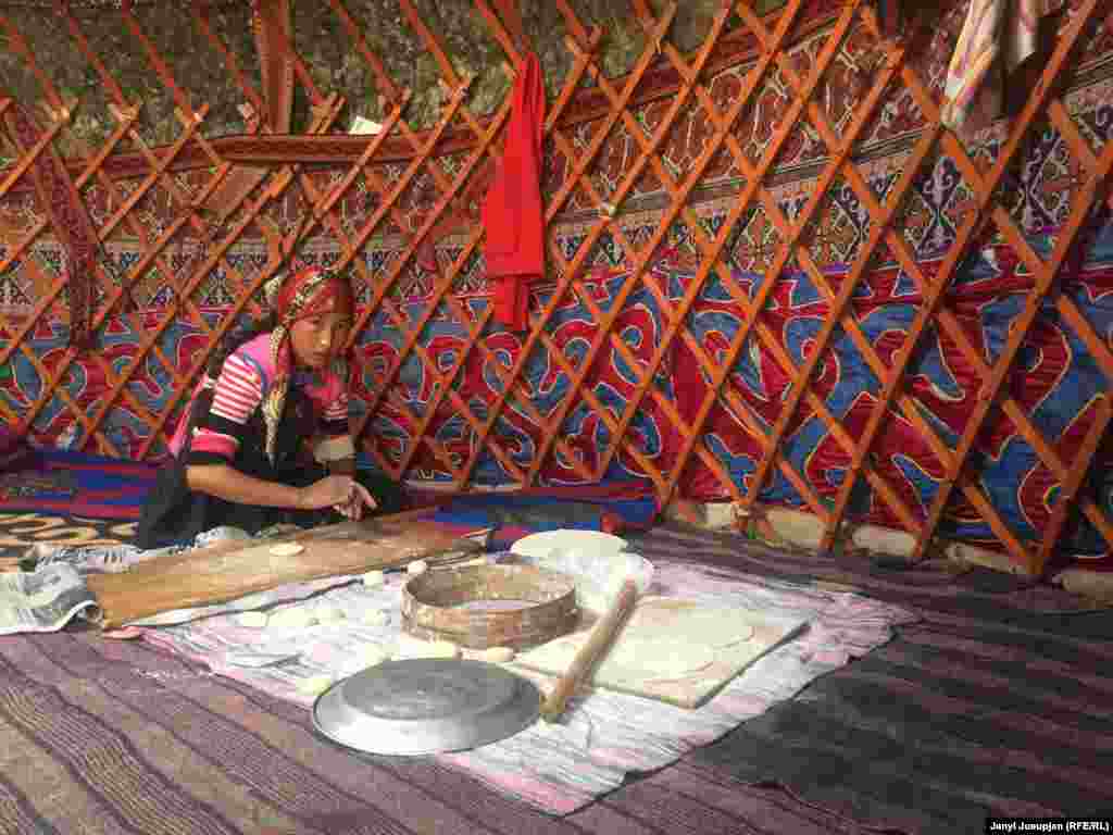 A girl making dough. Flour for bread, as most other foodstuffs, is brought in from other areas. The local diet is mainly based on meat and dairy products.