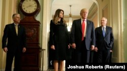 U.S. President-elect Donald Trump (2ndR) answers questions as his wife Melania Trump and Senate Majority Leader Mitch McConnell (R-KY) watch on Capitol Hill in Washington, U.S., November 10, 2016.