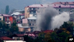 Smoke rises after shelling in Nagorno-Karabakh's main city, Stepanakert, on November 4.