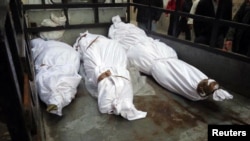 The bodies of what activists say are victims of shelling by the Syrian Army are seen in the Sunni district of Bab Amro in Homs on February 8.