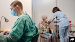 U Poljskoj od oko 38 miliona stanovnika upotrebljeno je do sada 13,76 miliona doza vakcina od čega preko devet miliona čeka na drugu dozu (na fotografiji vakcinacija u Poljskoj, januar 2021)