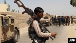 Afghan forces prepare for combat during an ongoing battle with Taliban in the Nad-e Ali district of Helmand Province on August 10.