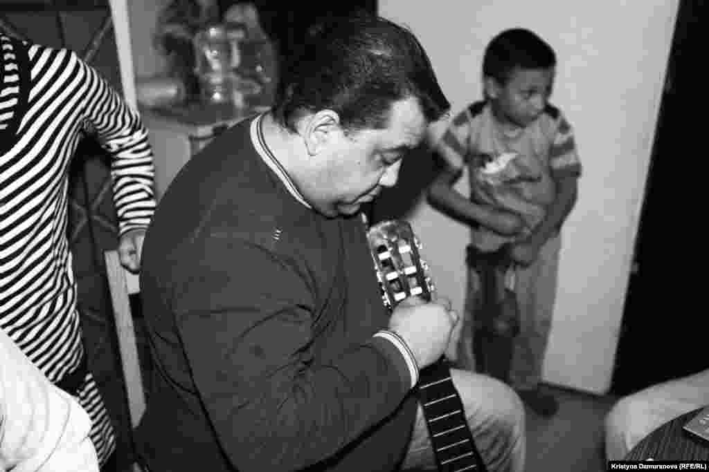 Emil Cina Sr., a musician, tunes up his guitar. He perform two to three times a week with four other musicians in his band, Benga Show, which has been praised in the Czech press for its &quot;authentic Romany feeling.&quot;